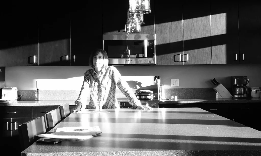 Black and white photo of Alyson in kitchen